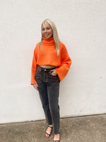 Orange ribbed turtleneck cropped sweater